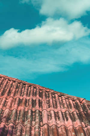 Old house roof with white cloud in background, copy space included