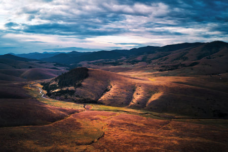 Barren landscape of Zlatibor mountain hill slopes in autumn sunset, aerial view from drone povの写真素材