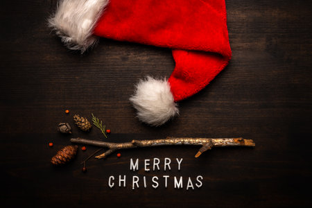 Santa Claus hat and Merry Christmas text flat lay top viewの写真素材