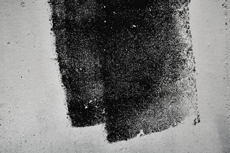 Abstract grunge texture pattern of black paint on white wall, dry brush techniqueの写真素材