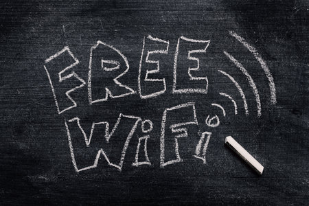 Free Wi-Fi sign written in chalk on grunge blackboardの写真素材