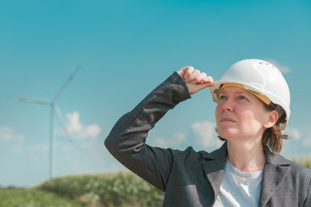 Portrait of female engineer on modern wind turbine farm during maintenance project planningの写真素材
