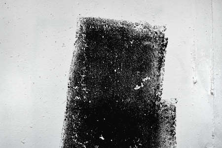 Abstract grunge texture pattern of black paint on white wall, dry brush technique