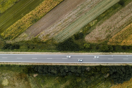 Three white cars on the road, aerial view top down from drone povの写真素材