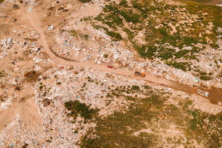 Aerial view of garbage trucks on landfill garbage dump site from drone povの写真素材