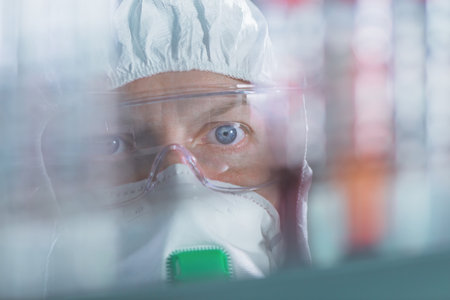 Virologist healthcare professional analyzing blood test sample in lab tubes, close up of medical worker working, selective focusの写真素材