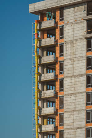 High-rise skyscraper building under construction with sky as copy spaceの写真素材