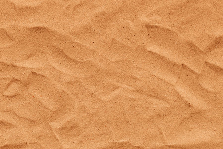Texture of yellow beach sand as summer season background, top view textured surfaceの写真素材