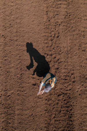 Female farmer examining ploughed field soil, drone photography top view of woman agronomist workingの写真素材