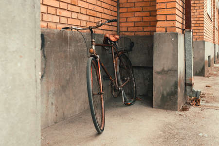 Old bicycle leaning on the building wall, selective focusの写真素材