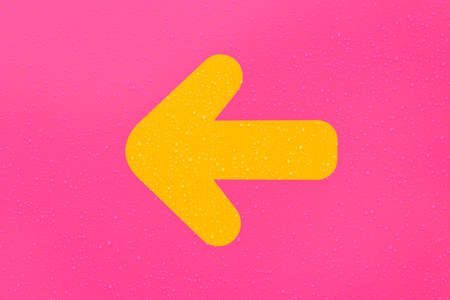 Yellow direction arrow on pink background covered with raindrops, sign pointing to the leftの写真素材