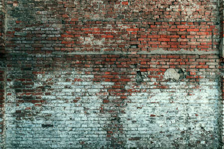 Rustic exterior brick wall surface as weather worn backgroundの写真素材