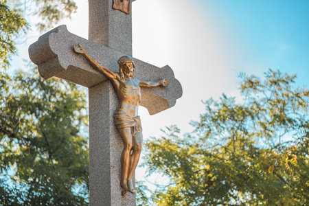 Crucifixion, statue of Jesus Christ on concrete cross on cemetery, selective focusの写真素材