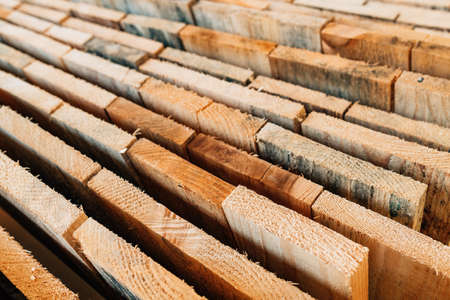 Stacked rustic wooden boards as construction material, selective focusの写真素材
