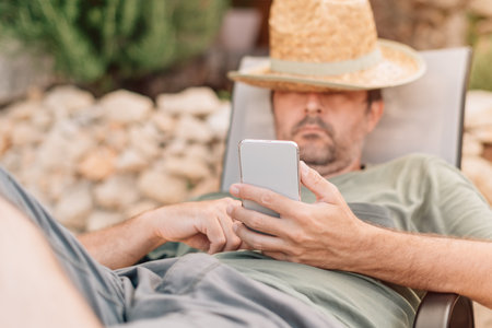 Freelancer and digital nomad working on smartphone during summer vacation holiday on apartment...