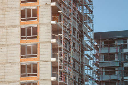 High-rise skyscraper building under construction with sky as copy spaceの写真素材