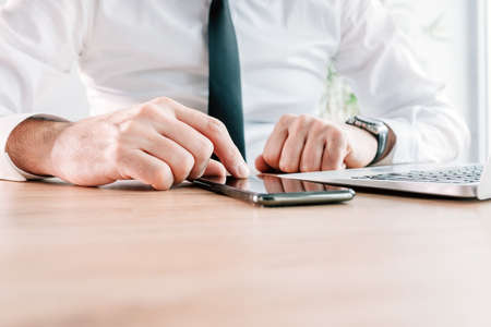 White collar entrepreneur using mobile smart phone for business communication, copy space included...