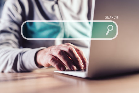 Internet search, casual man using laptop computer, selective focusの写真素材