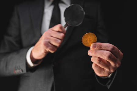 Tax agency officer inspecting Bitcoin cryptocurrency exchange transaction, conceptual imageの写真素材