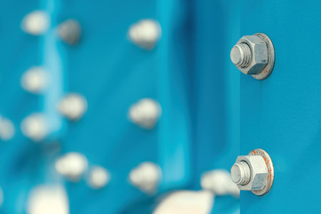 Large industrial screws nuts and bolt fastening machinery steel plates, selective focusの写真素材