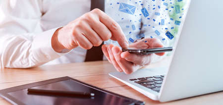 Businessman sending bulk text messages from from business office, selective focus
