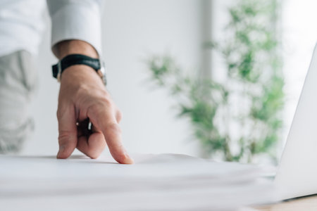 Businessman pointing finger to a document on office desk, selective focusの写真素材