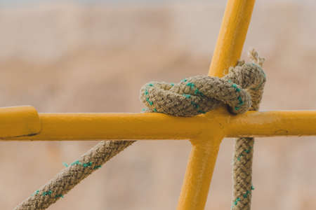 Old rope tied to a knot, close up with selective focusの写真素材