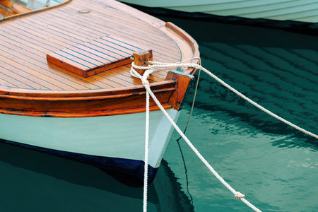 Wooden fishing boat bow in seaside marina, nautical vessel moored to a dockの写真素材
