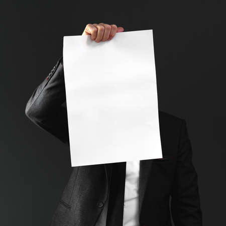 Businessman holding blank poster paper as mockup copy space for text of graphics, square image with...
