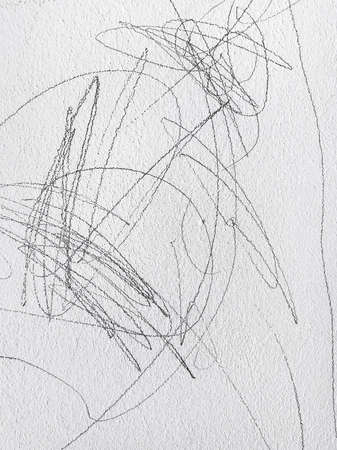 Scribble pattern on the wall, messy writing of a small child as backgroundの写真素材