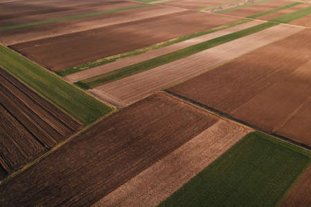 Aerial view of tilled fields in spring from drone povの写真素材