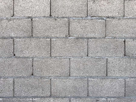 Exterior wall made of concrete blocks as background or construction industry texture