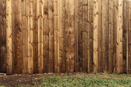 Backyard wooden fence as copy space and background, worn wood boards texture