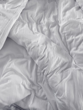 Messy white bed duvet cover as background