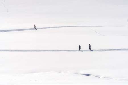 Unrecognizable people hiking in snowy landscape in winter, Zlatibor region in Serbiaの写真素材