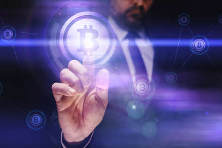 Businessman trading with bitcoin cryptocurrency on virtual digital screen, selective focus