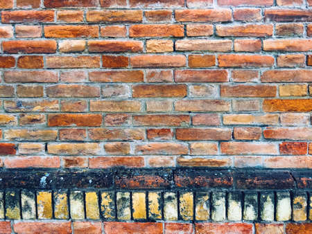 Brick wall background, texture of an old brickwall with worn surface