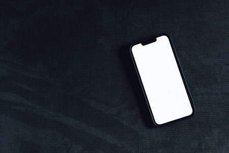 Smartphone device with mockup screen on living room sofa, top viewの写真素材