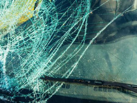 Broken windscreen glass after car accident, close up