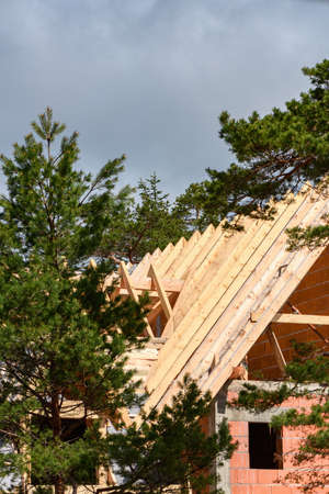 Wooden beams for house roof construction, building a new homeの写真素材