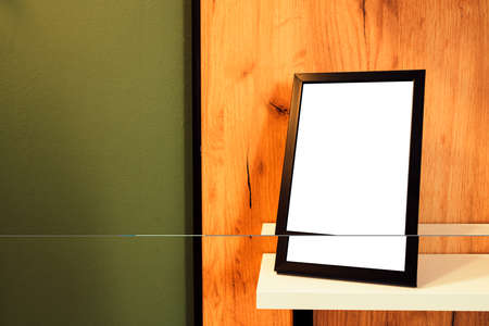 Blank picture frame on the shelf as mockup copy space for graphic or text