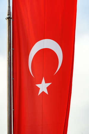 National flag of Turkey or Republic of Turkiye on post. Red banner with white star and crescent....