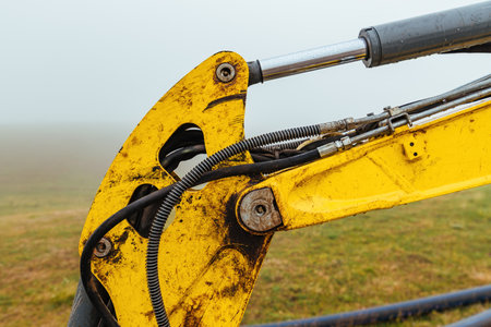 Excavator boom arm with hydraulic cylinder stick, selective focusの写真素材