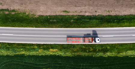 Aerial shot of truck with semi-trailer for container transport from drone pov, directly above