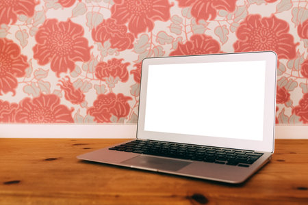 Laptop computer with blank mockup screen on living room desk, selective focusの写真素材