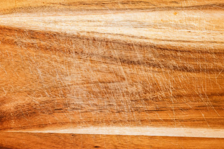 Worn wooden cutting board texture as background, top viewの写真素材