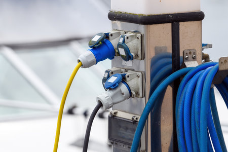 Electric boat charging station at the river quay, selective focusの写真素材