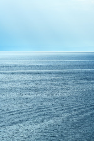 Morning sunlight beaming through clouds at Kvarner gulf of Adriatic sea in Croatiaの写真素材