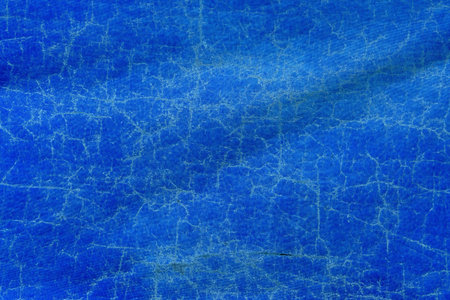 Worn blue tarpaulin material texture as background, top viewの写真素材