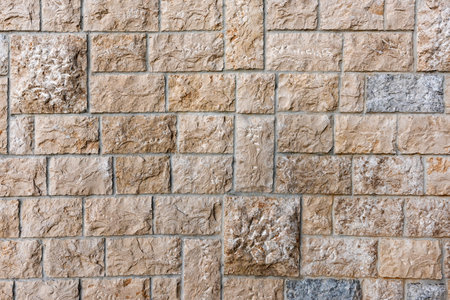 Stone tiled facade wall of a building as background